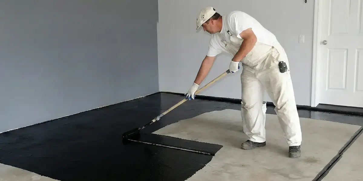 basement waterproofing professional applying waterproof coating to protect a basement floor in Cape Coral, FL