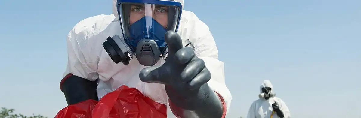 sewage clean up technician wearing protective gear handling biohazard materials in Cape Coral, FL