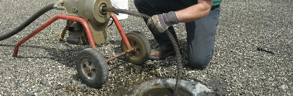 sewer rodding technician actively removing blockages from a sewer line in Cape Coral, FL
